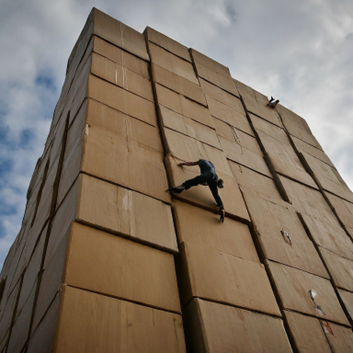 scalability upgrades and future-proofing, image of a man scalling a large stack of big boxes